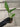 An Adanson's Monstera plug held in a gloved hand. The plug is in an ellepot, and shows a developed root system. One of the leaves displays the plant's characteristic holes.